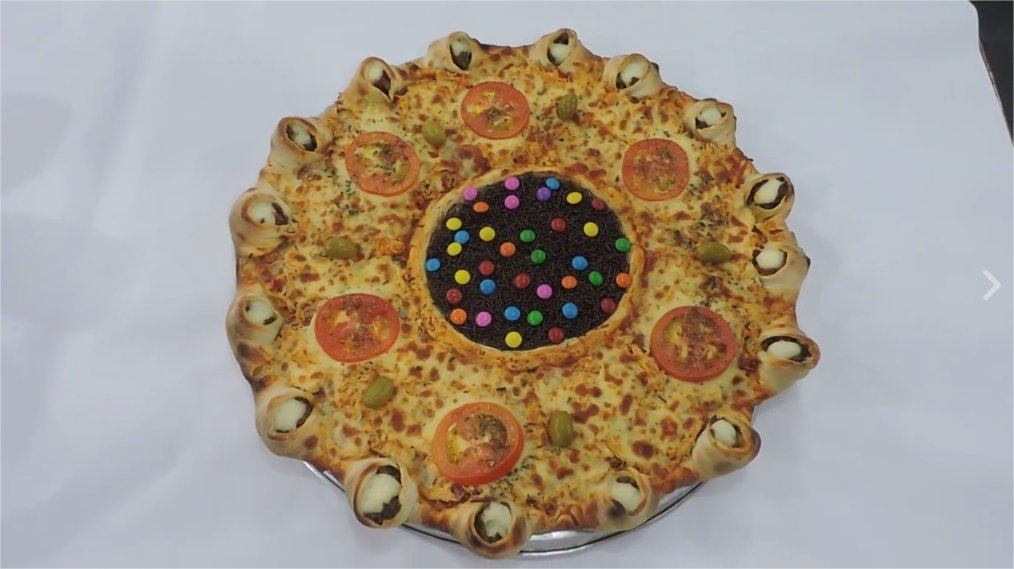 a concentric circle of pizza wrapped around a brownie topped with M&Ms