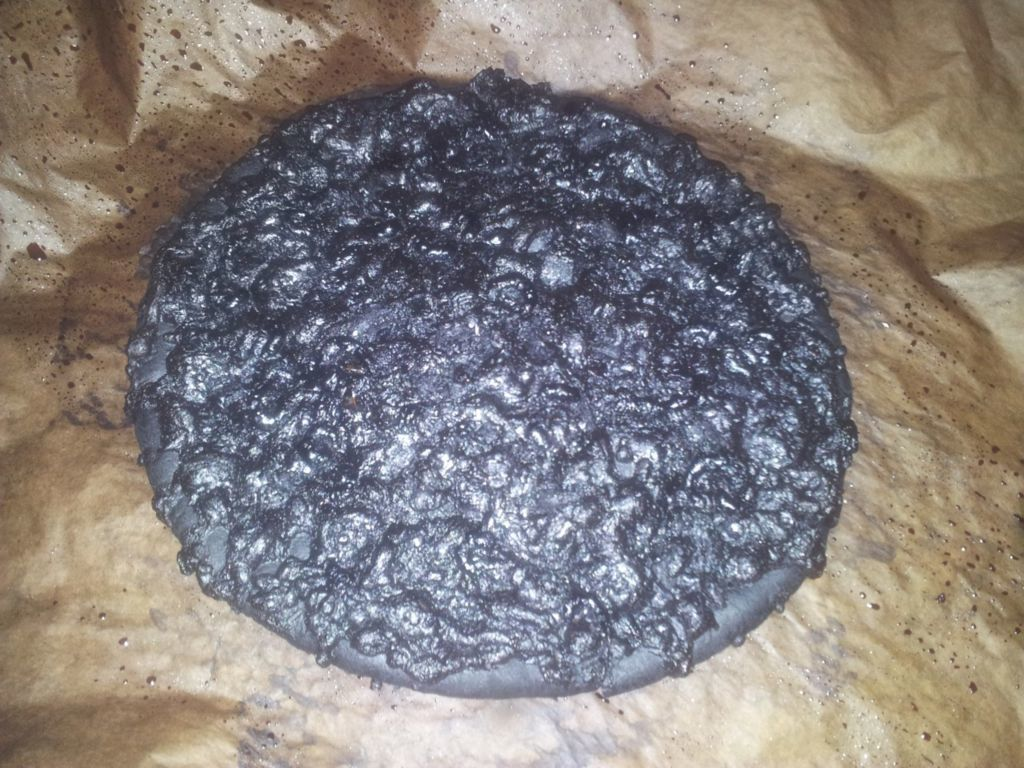 A blackened, burnt pizza.